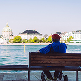 Man sitting on a bench looking at the sea