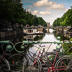 Bicycles leaning on bridge in front of the lake