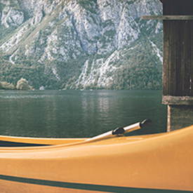 Canoe on the lake surrounded by mountains