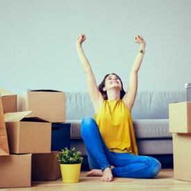Woman next to the boxes of a moving house