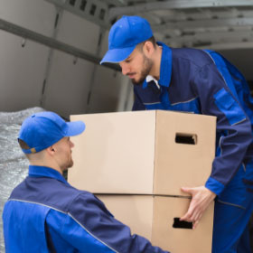 Transportistas cargando cajas en furgoneta